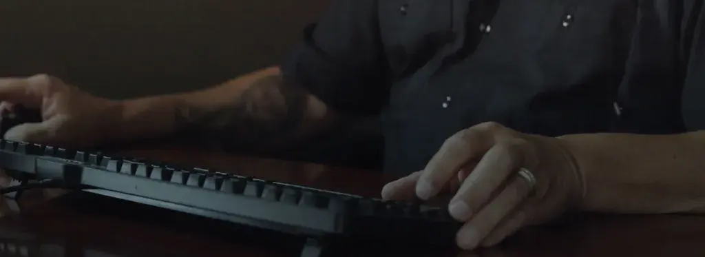 a person at a desk working on a laptop