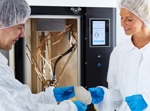 EXT 220 MED 3D printer with doctors looking at a part